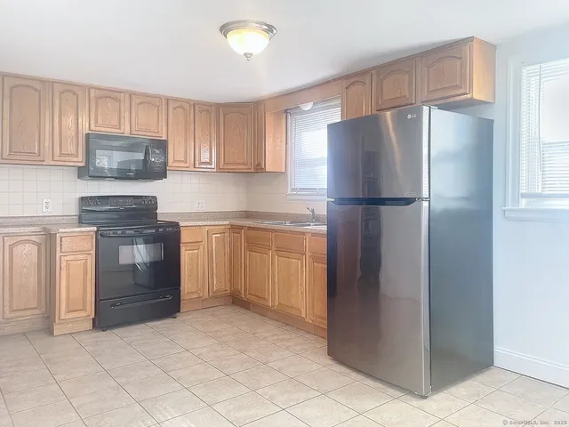 a kitchen with a refrigerator sink and stove