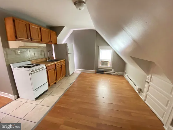 a view of kitchen with cabinets and wooden floor