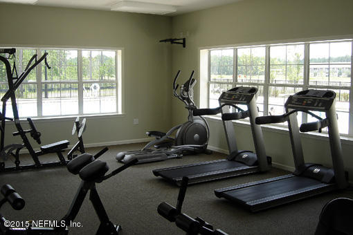 1104 Golden Lake Loop St. Augustine, FL 32084 - Photo 4 of 6 a room with gym equipment and a large window