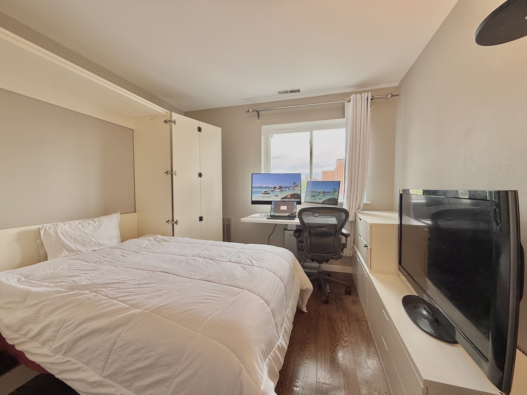 20 Stearns Road, Unit 45 Brookline, MA 02446 - Photo 15 of 22 a large bed sitting in a bedroom next to a window