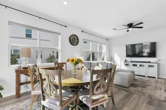 a view of a dining room with furniture and a flat screen tv