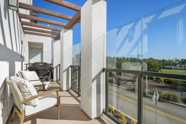 a view of a chairs and table in a balcony