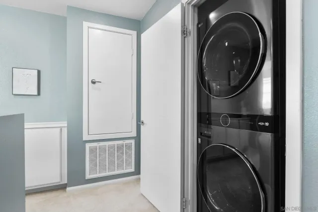 a spacious bedroom with a bed a window and a chandelier
