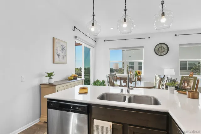 a kitchen with a sink and a clock on the wall