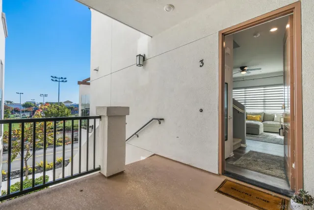 a view of a hallway with a glass door and shower