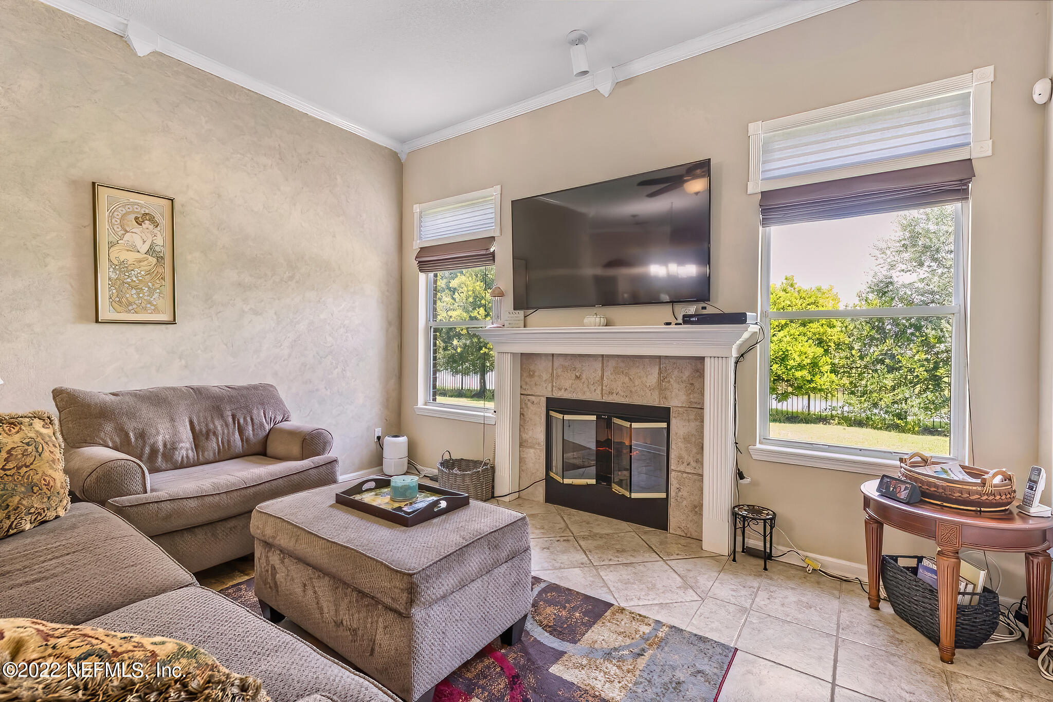 855 East Red House Branch Road St. Augustine, FL 32084 - Photo 14 of 43 a living room with furniture a flat screen tv and a fireplace