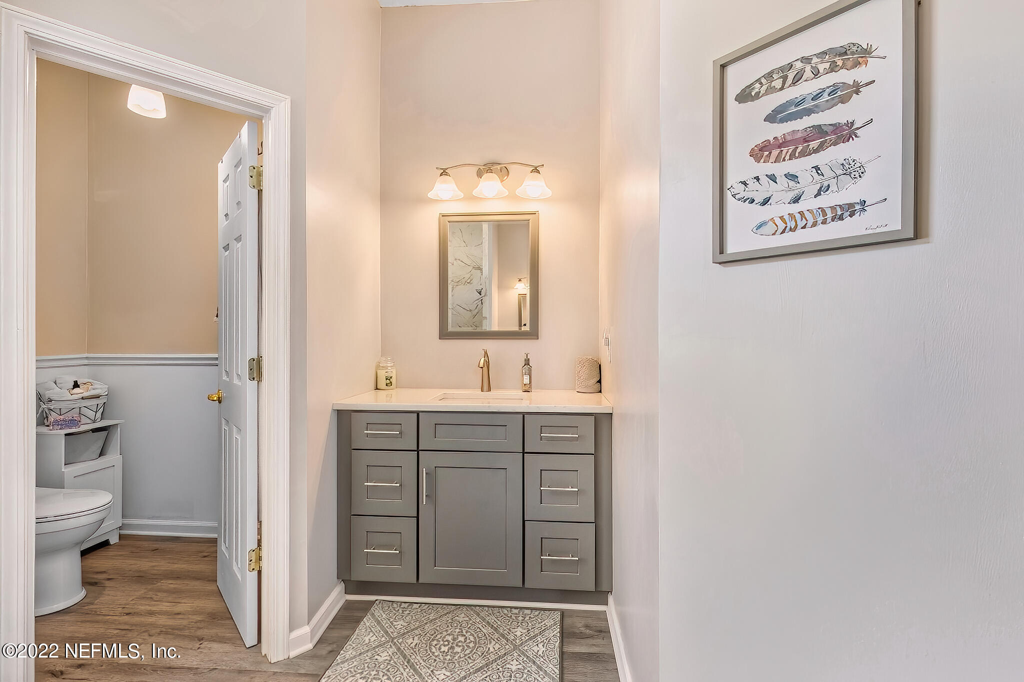 855 East Red House Branch Road St. Augustine, FL 32084 - Photo 23 of 43 a bathroom with a sink a toilet and a mirror