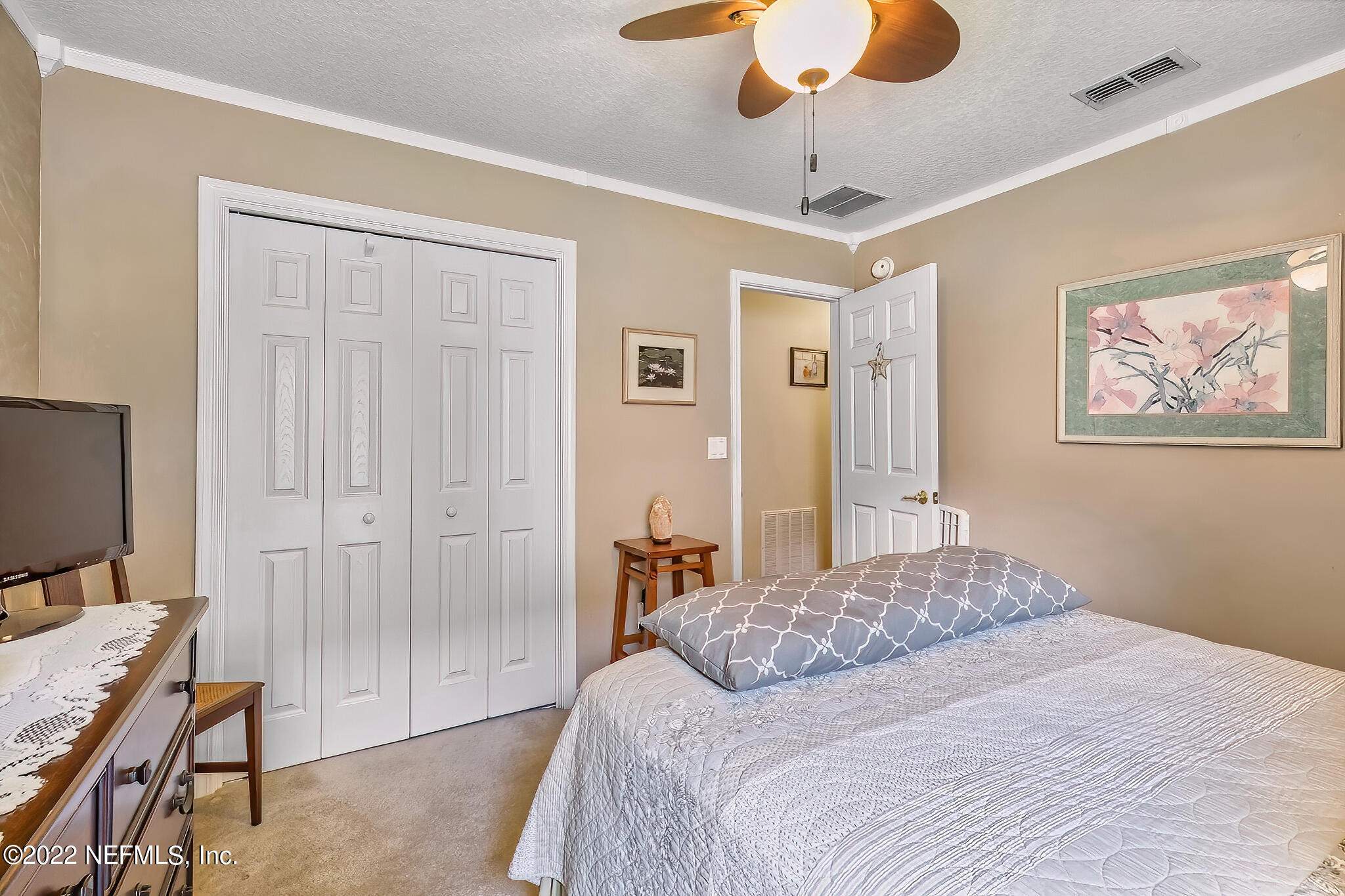 855 East Red House Branch Road St. Augustine, FL 32084 - Photo 25 of 43 a bedroom with a bed and a chandelier