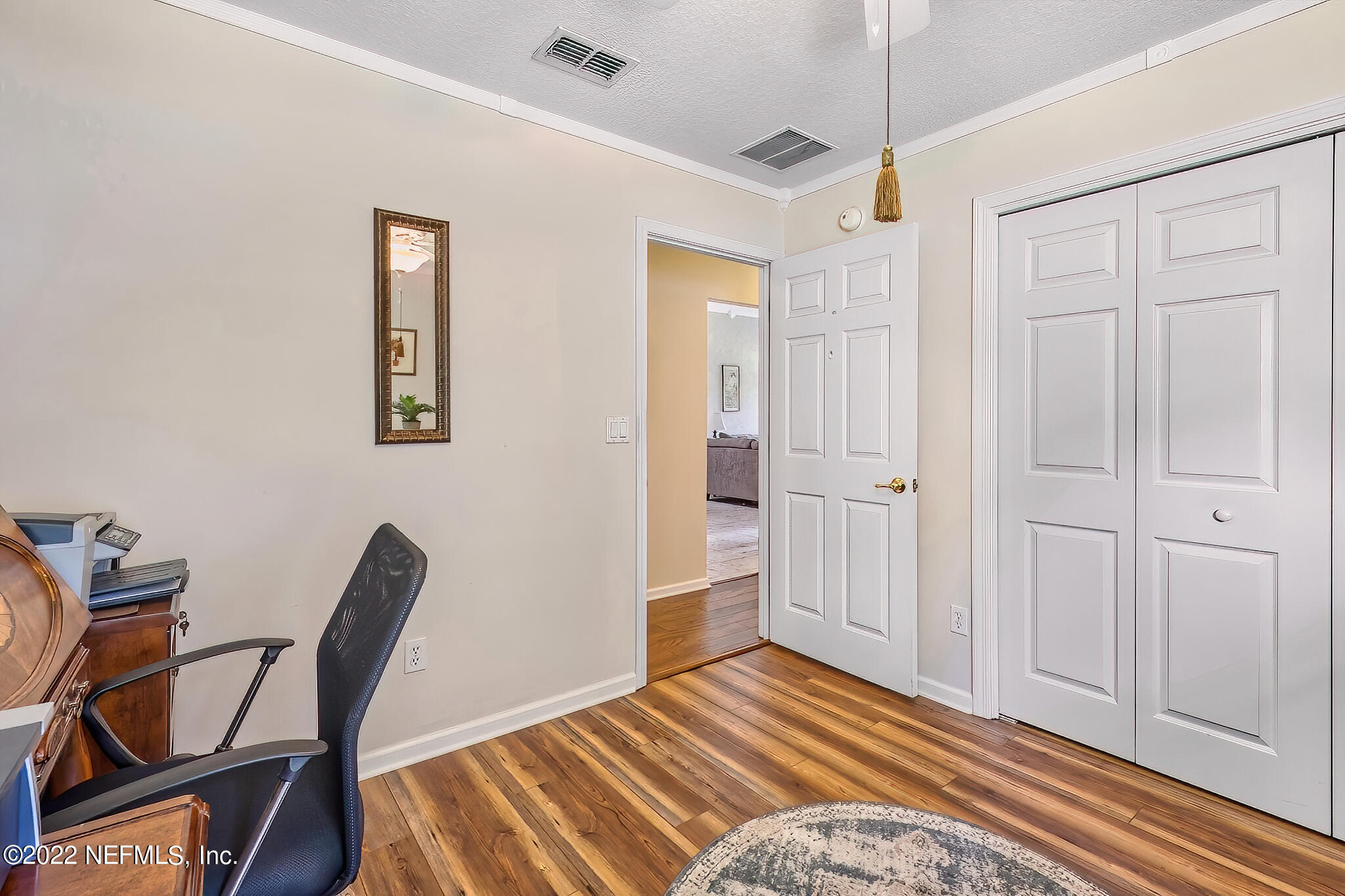 855 East Red House Branch Road St. Augustine, FL 32084 - Photo 27 of 43 a bedroom with a bed and a chair