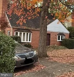 front view of a house with a tree