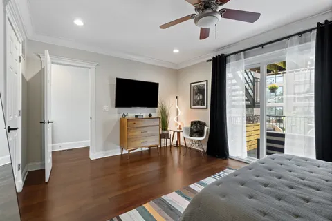 a bedroom with furniture and a flat screen tv