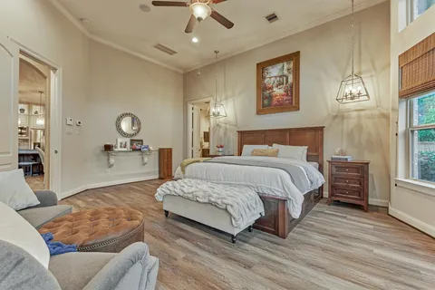 a bedroom with a large bed and a chandelier