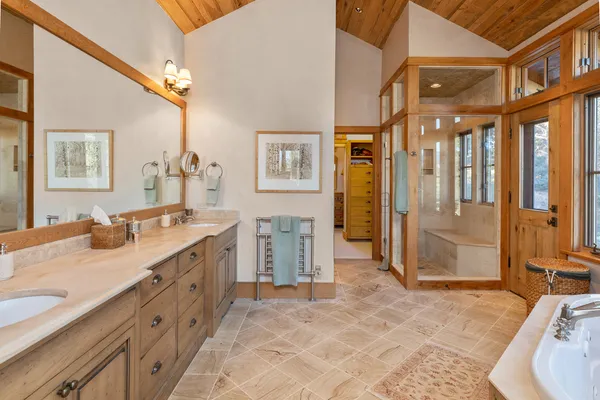 a spacious bathroom with a granite countertop sink and a mirror