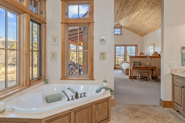 a living room with furniture and large windows