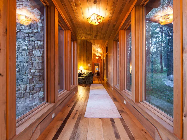 a view of a balcony with wooden floor and brick walls