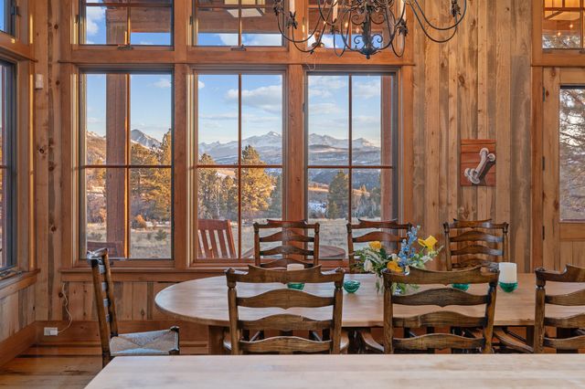 a dining room with furniture and wooden floor