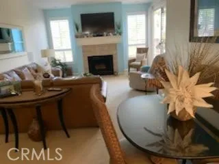 a living room with furniture fireplace and a flat screen tv