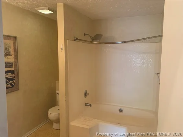 a bathroom with a shower and a toilet