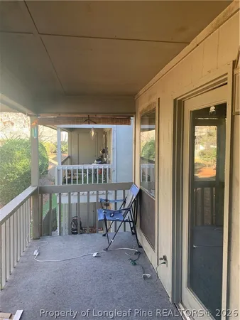 a view of a porch with chairs and backyard