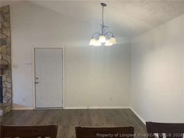 a view of a room with a sink and chandelier fan