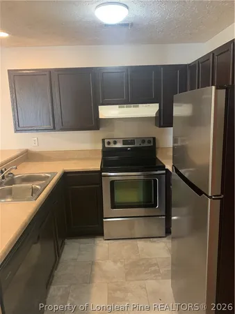 a kitchen with a stove and a refrigerator