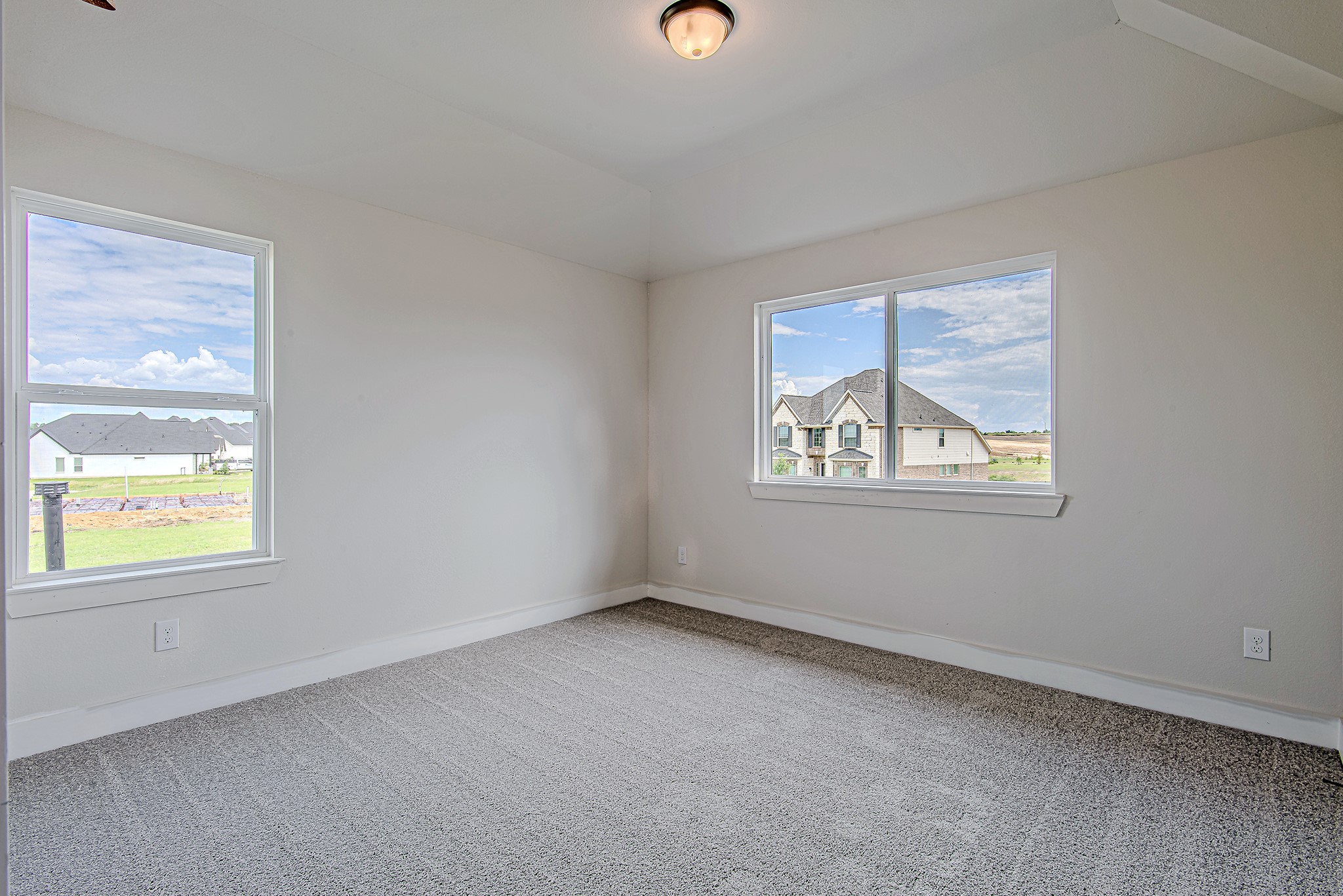 141 Peninsula Point Drive Montgomery, TX 77356 - Photo 35 of 47 Secondary upstairs bedroom with plush carpeting, dual windows for abundant natural light, and a charming view of the neighborhood.