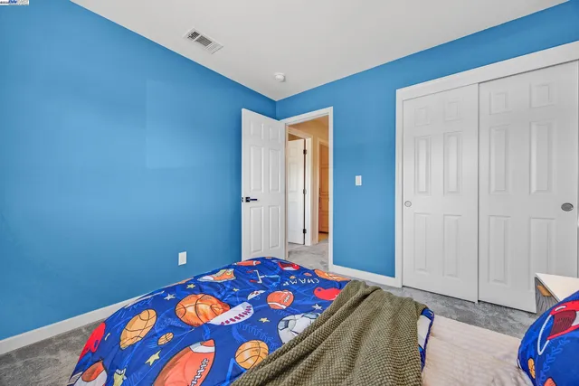 a bedroom with a bed and a lamp