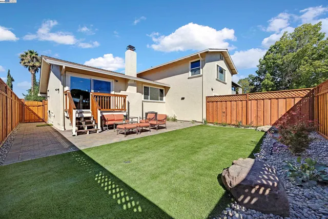 a view of a house with backyard and porch
