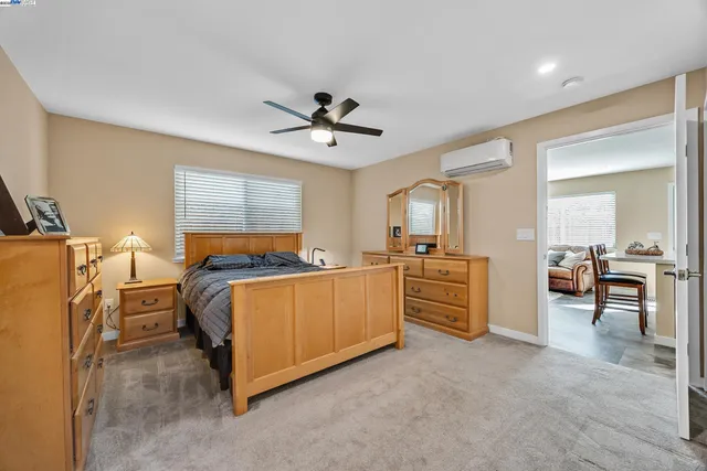 a bed room with furniture and a flat screen tv