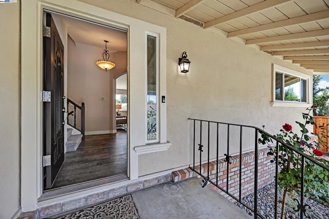 a view of a hallway with wooden floor and stairs