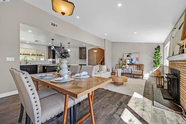 a dining room with wooden floor and furniture
