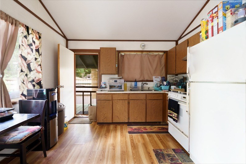 4909 Menehune Road, Unit 2 Waimea, HI 96796 - Photo 6 of 13 a kitchen with a refrigerator and a stove