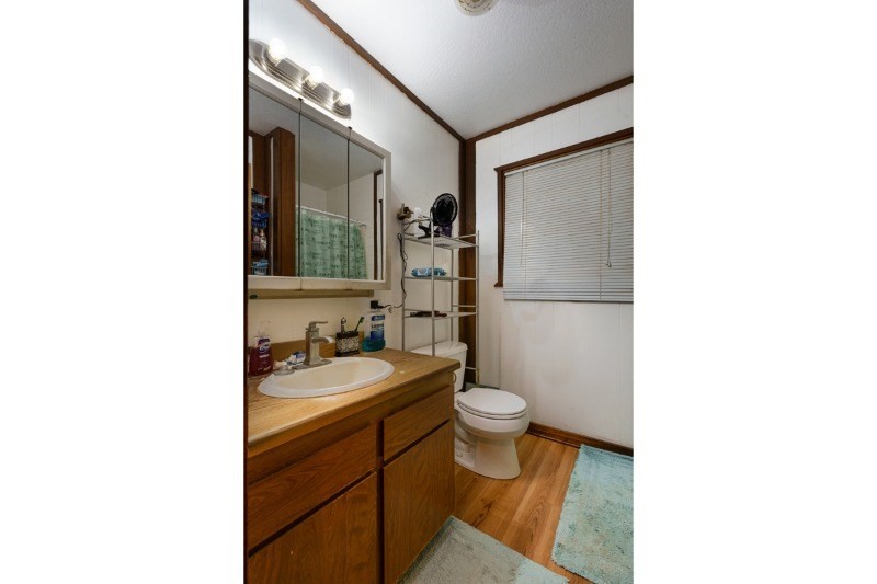4909 Menehune Road, Unit 2 Waimea, HI 96796 - Photo 8 of 13 a bathroom with a sink toilet a mirror and shower