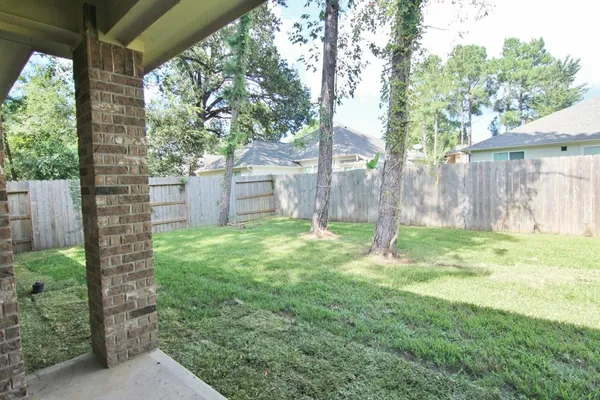 a backyard of a house with lots of green space and fountain