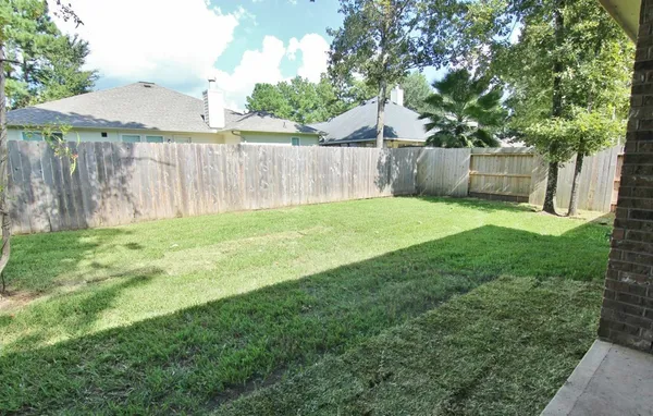 a view of a backyard with a small cabin and a chair