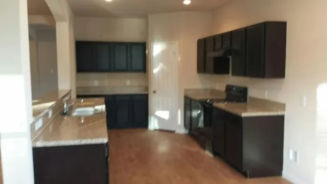 a kitchen with a sink and cabinets