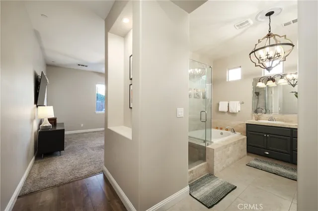 a bathroom with a double vanity sink a toilet a mirror and shower