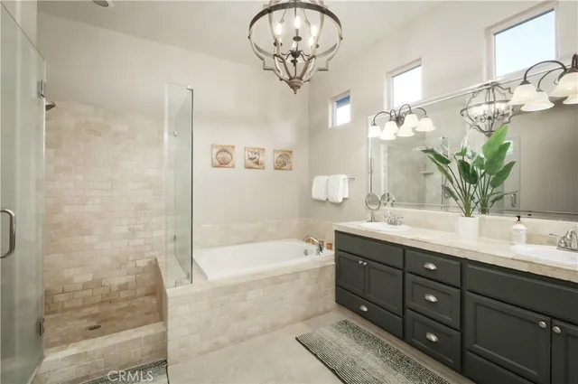 a bathroom with a tub a sink and mirrors