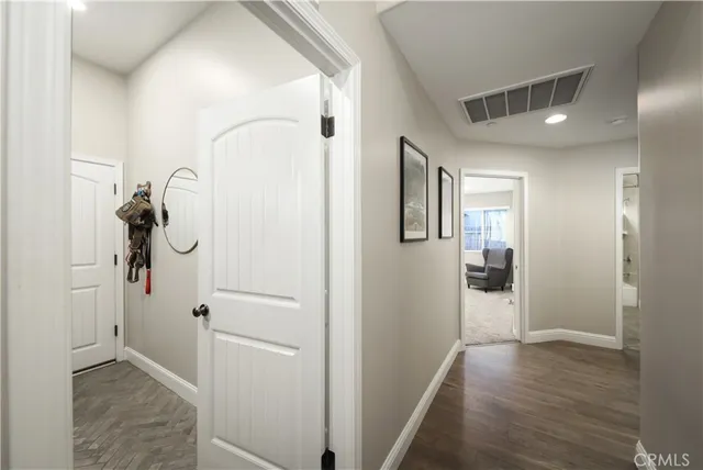 a view of a hallway with wooden floor and glass door