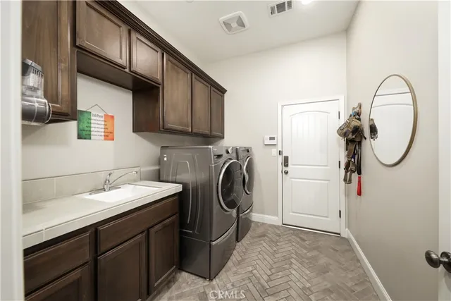 a utility room with sink dryer and washer