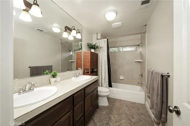 a bathroom with a bathtub shower sink double vanity and a mirror