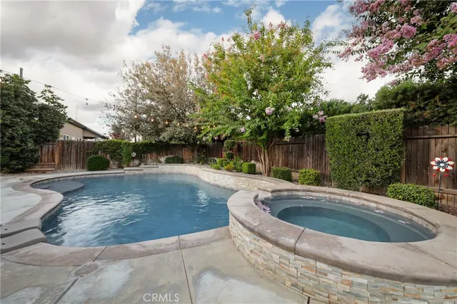 a view of a swimming pool with a yard