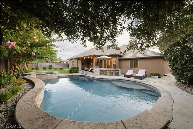 swimming pool view with a seating space