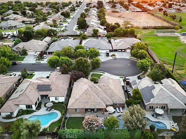 an aerial view of multiple houses with yard