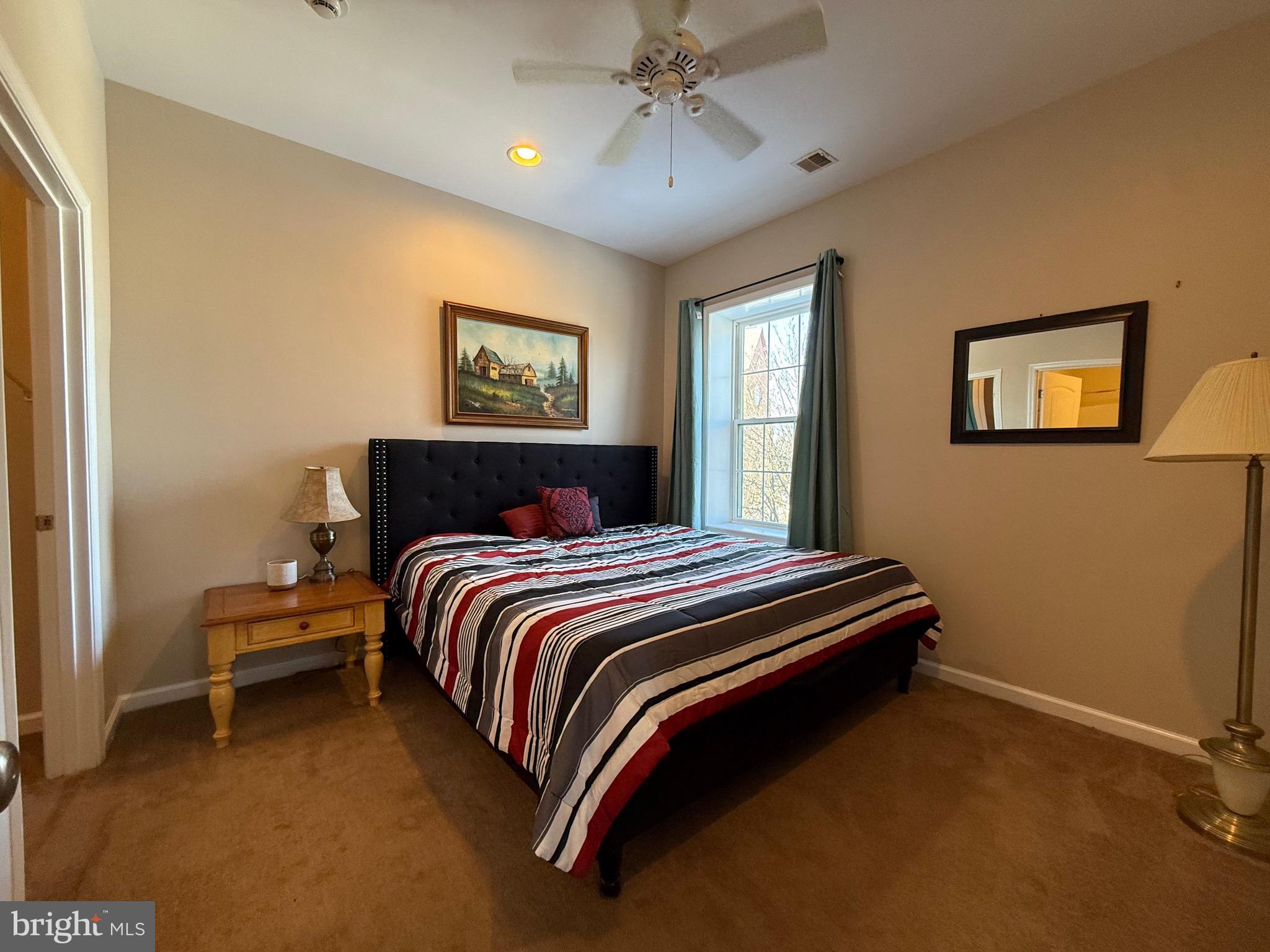2 South 3rd Street, Unit 1 Oxford, PA 19363 - Photo 8 of 14 a bedroom with a bed and a painting on the wall