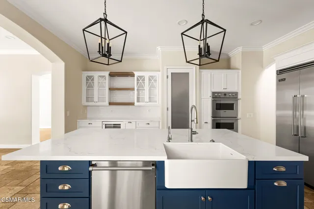 a spacious bathroom with a vanity a sink a mirror and a bathtub