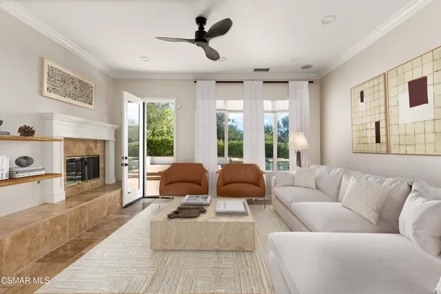 a view of a patio with couches table and chairs and potted plants