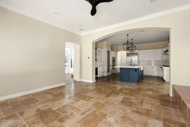 a view of a roof deck with couches and wooden fence