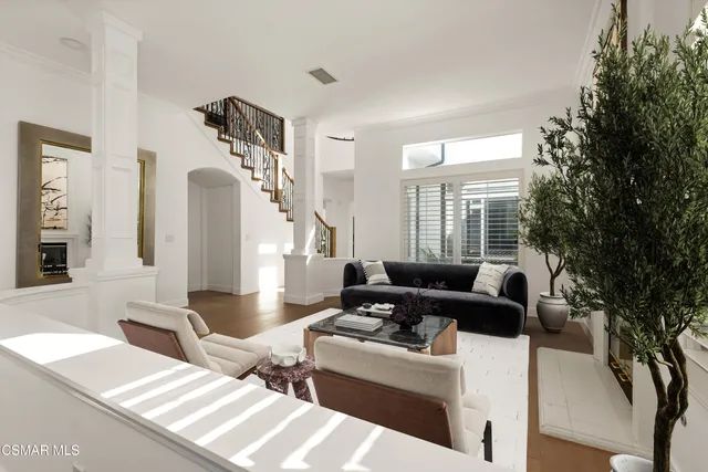 a view of an entryway with wooden floor and a living room
