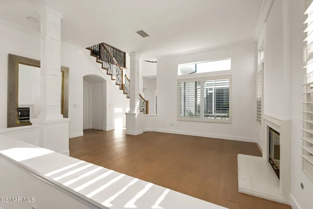 a living room with furniture and view of kitchen